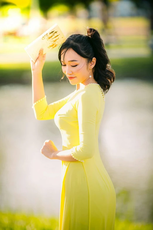 a pretty young lady wearing a yellow dress