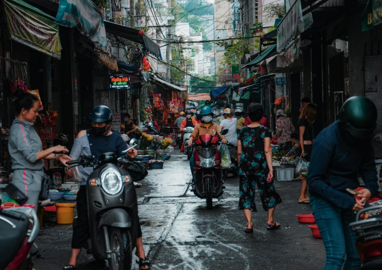 two people walking on a street next to stores