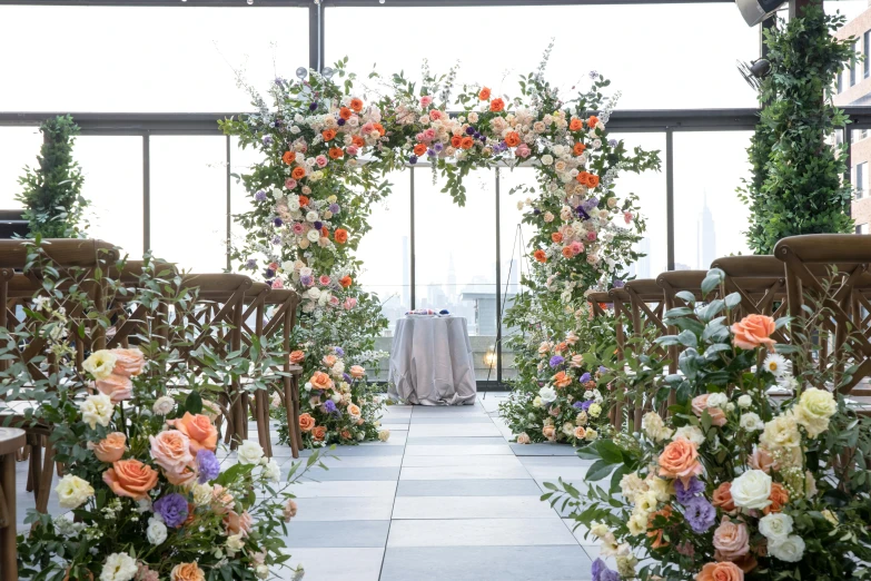 floral archway for a formal ceremony decorated with greenery and flowers