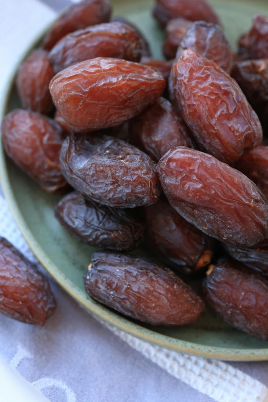 close up po of almonds in plate on cloth