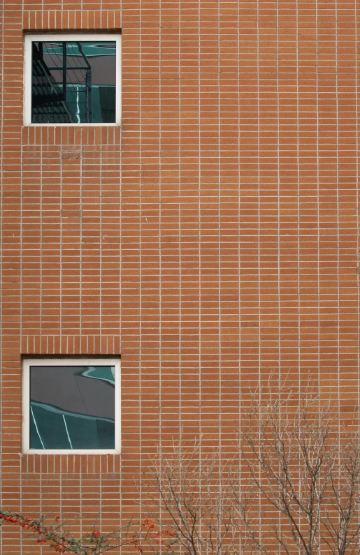 a window with broken glass beside a brick building