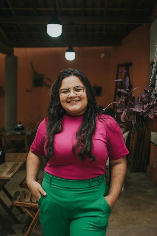 an overweight woman in bright pink and green pants