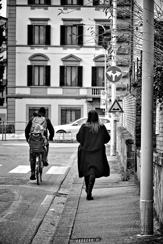 the woman is riding her bike down the road