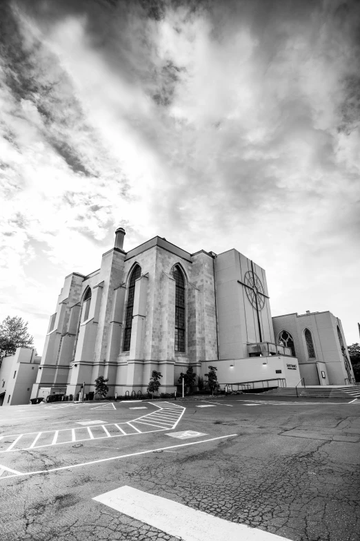 the sky is partly cloudy as it sits next to a church