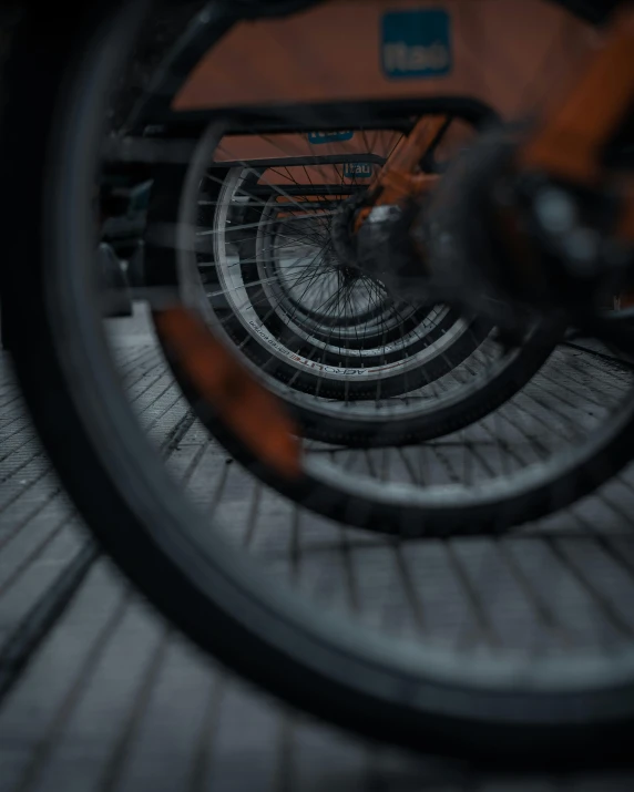 an orange bicycle leaning up on the ground
