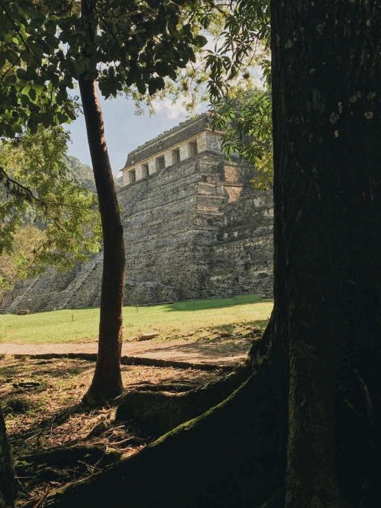 a large stone structure standing next to some trees