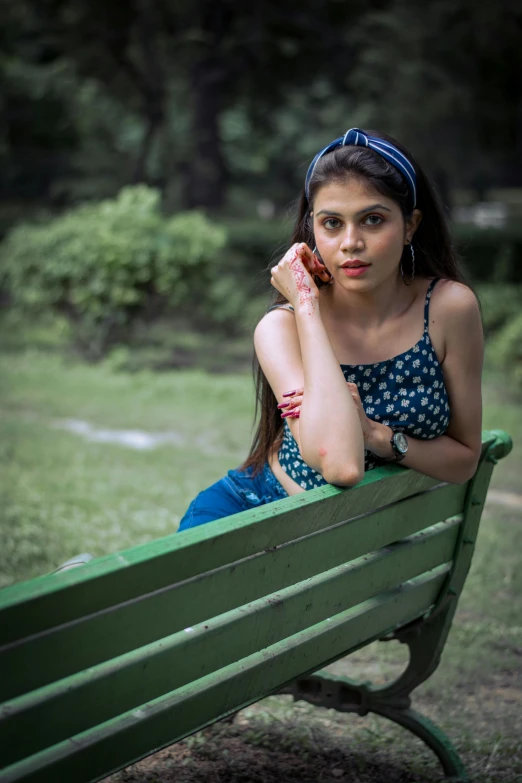 young woman sitting on bench and talking on phone