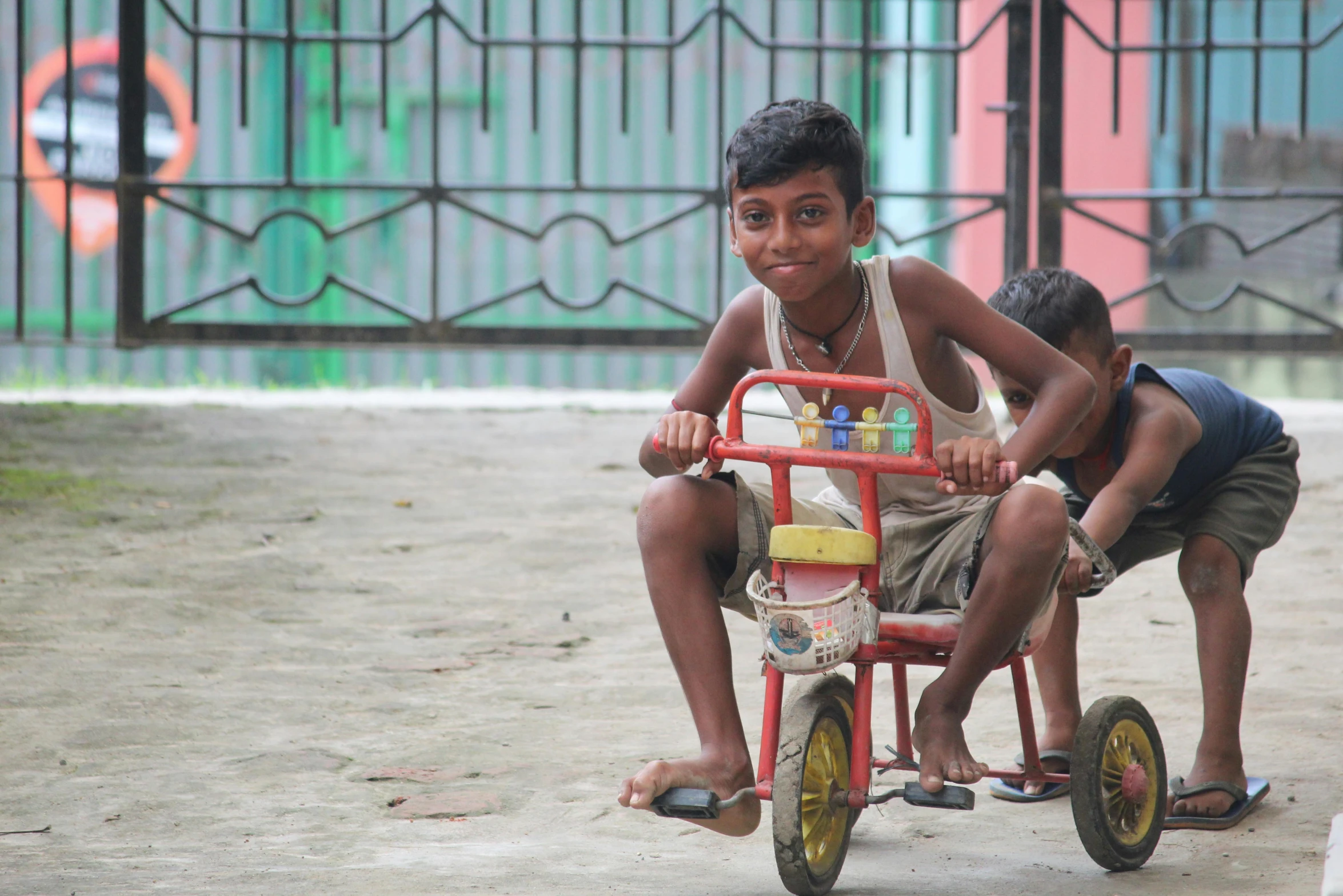 the children ride in the miniature tricycle