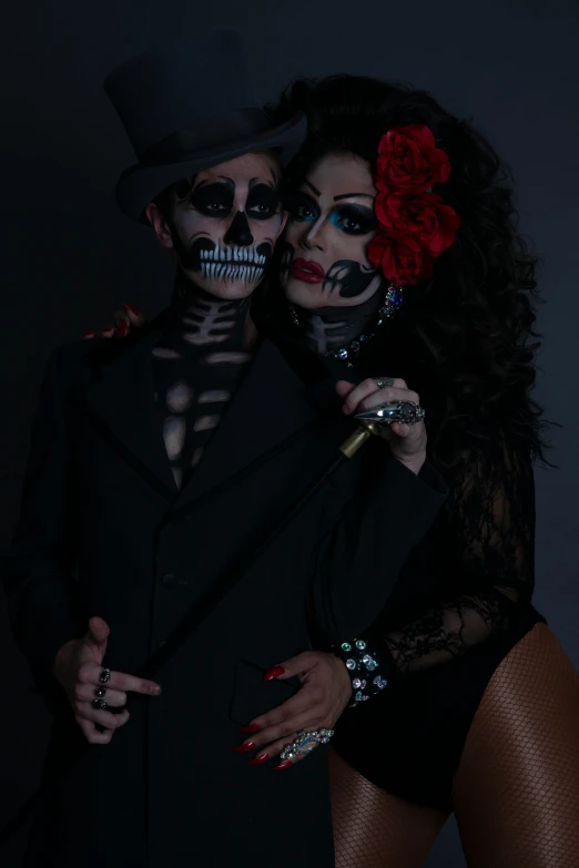 a man and woman dressed as skeletons pose for a po