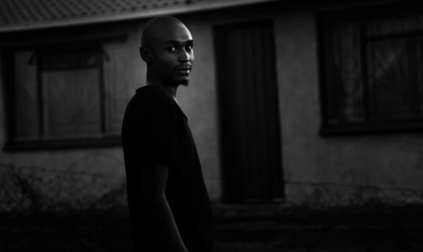 a black and white po of a person outside a house