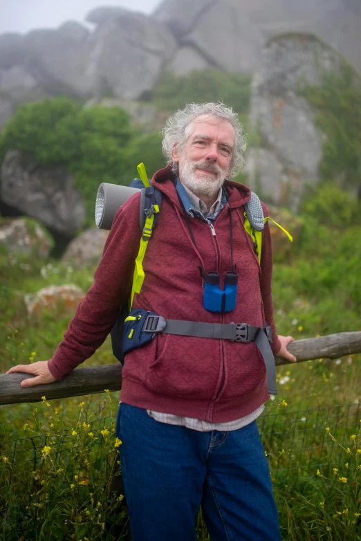 a bearded man with a beard wearing a backpack and hiking equipment