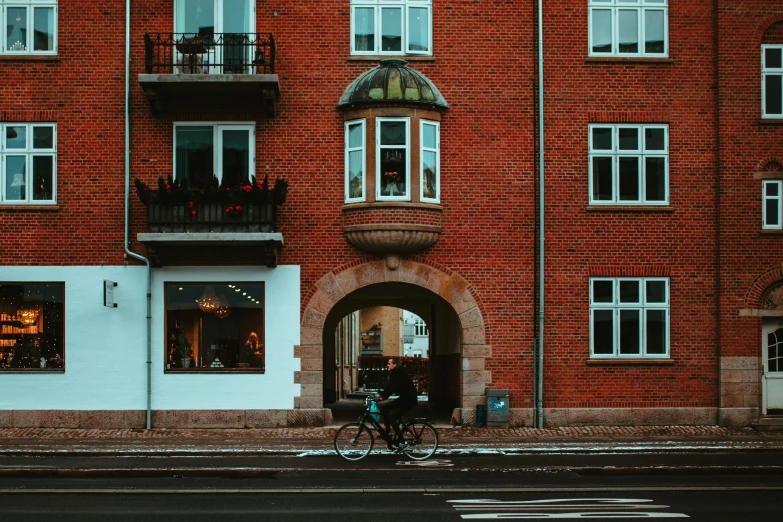 the bicycle is parked outside of a red brick building