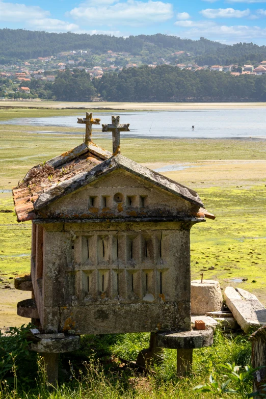 old brick church sitting on a grass covered hillside