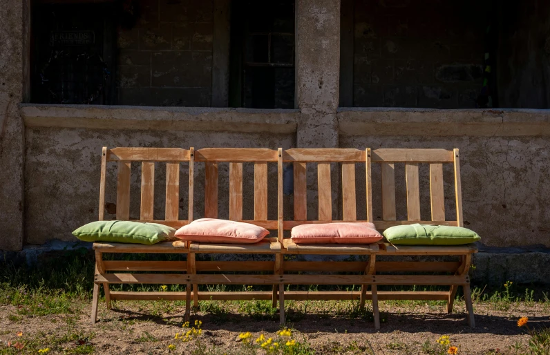 four seats in the grass with one bench on the side