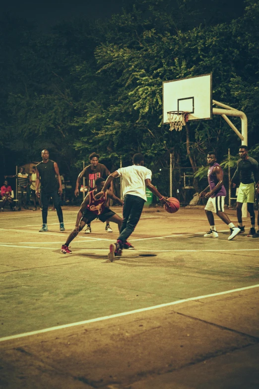 a man is running to block the ball during a basketball game