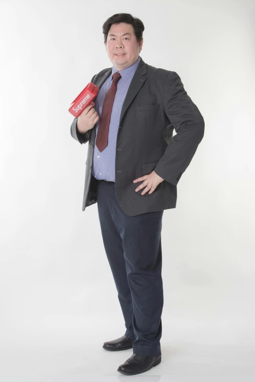 a man in suit and tie holding an empty box