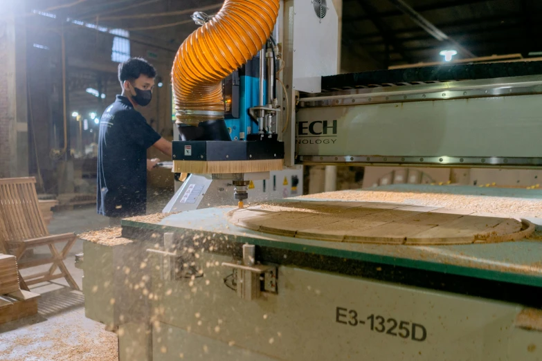 a man who is working on a machinery in a building