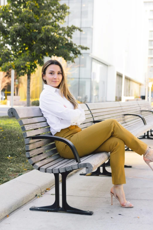 the woman is posing on the bench for a po