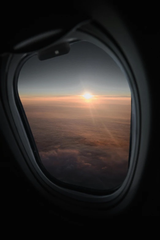 a window shows a sunset in the sky