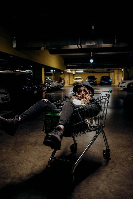 a girl in a cowboy hat, jeans and boots in a shopping cart