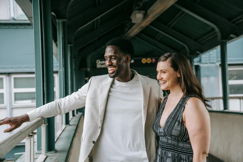 a couple standing outside of an outdoor covered area