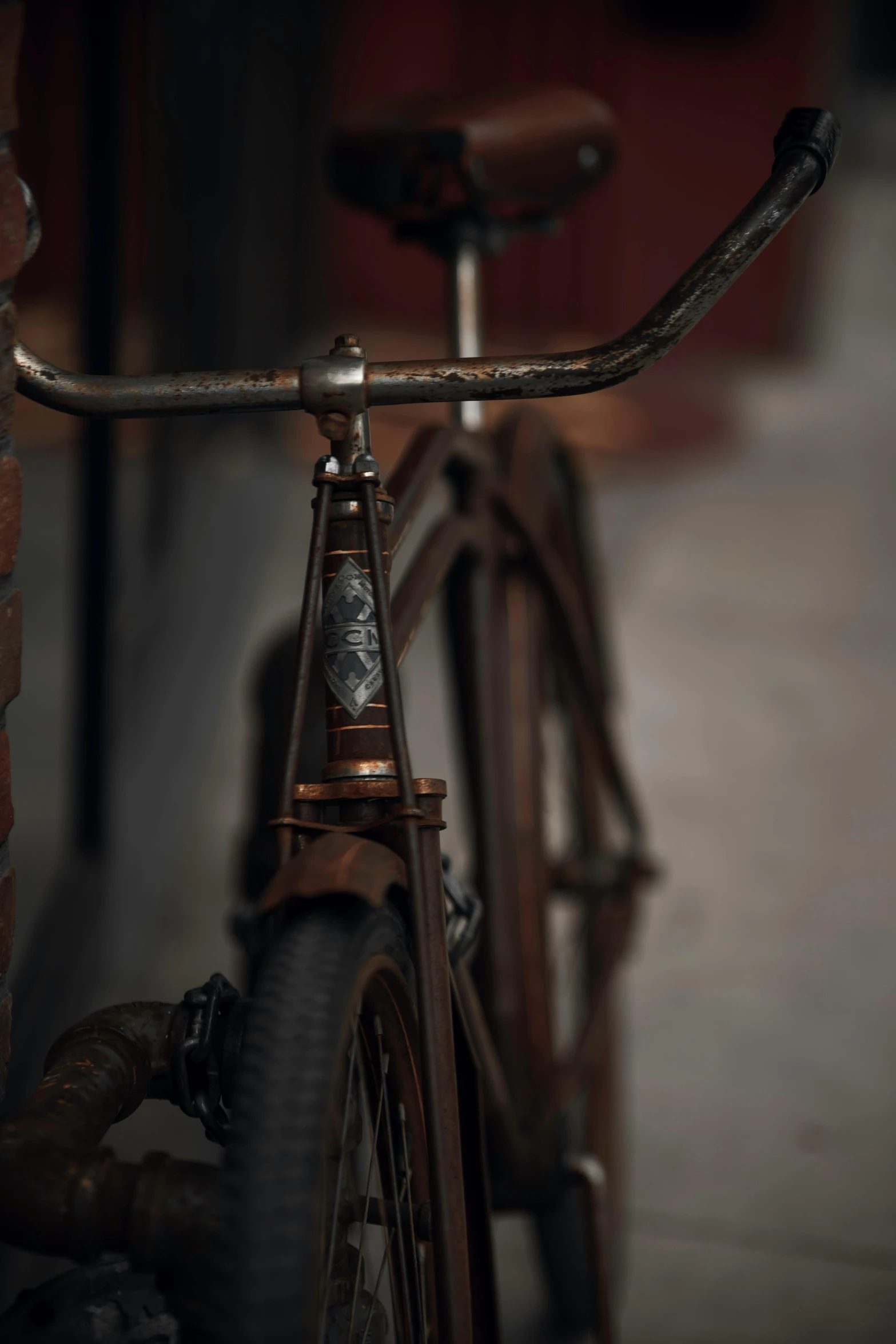 a bike parked next to a brick wall