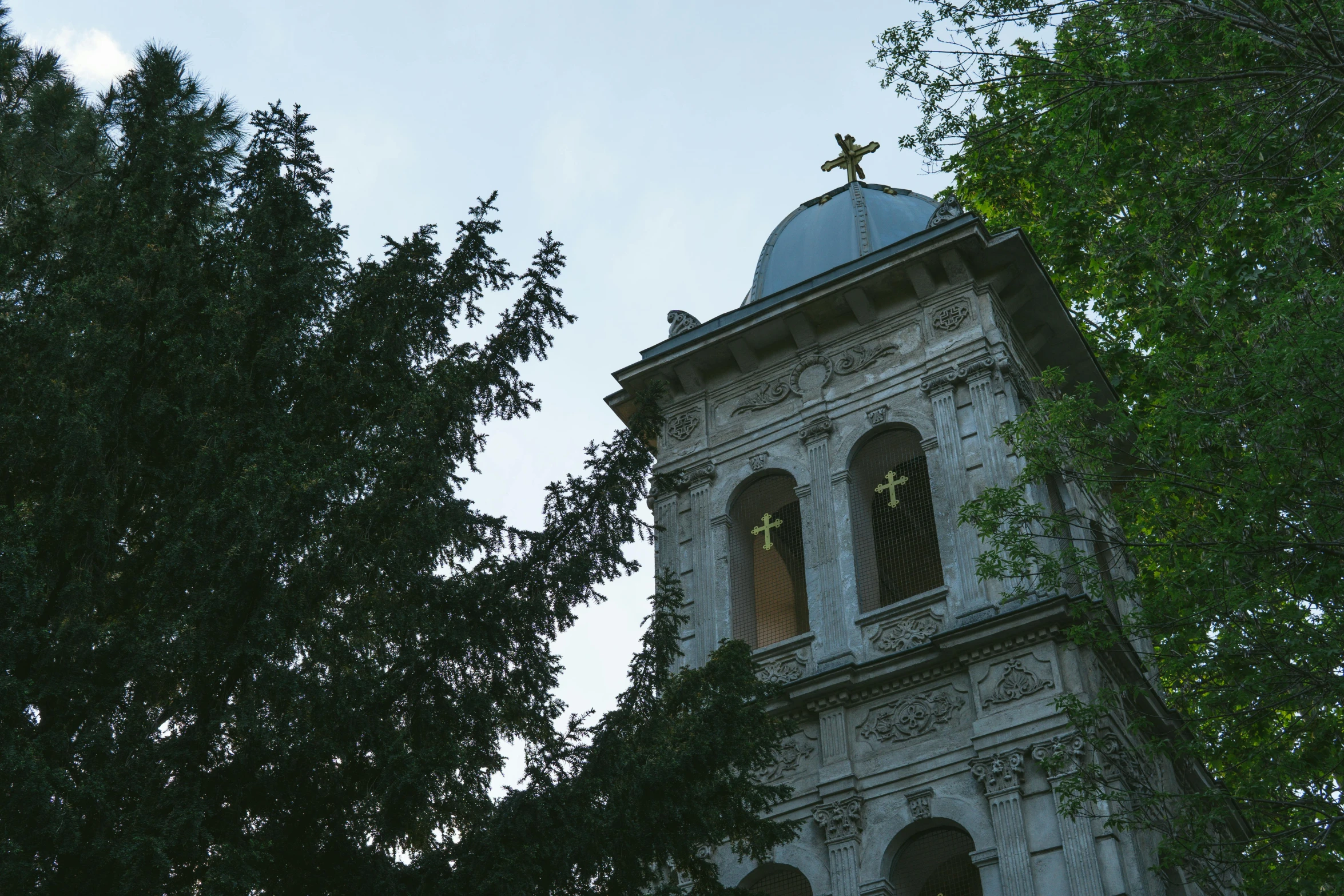 an old church tower with a cross on top