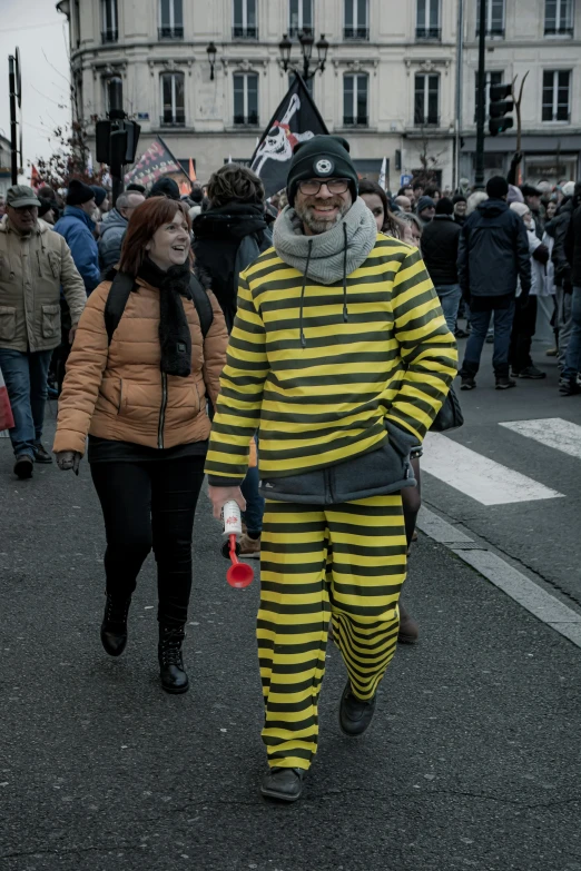 two men dressed in  pajamas walking down the street