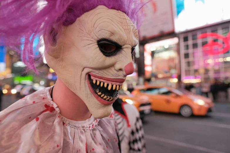 the creepy clown in the city is staring ahead