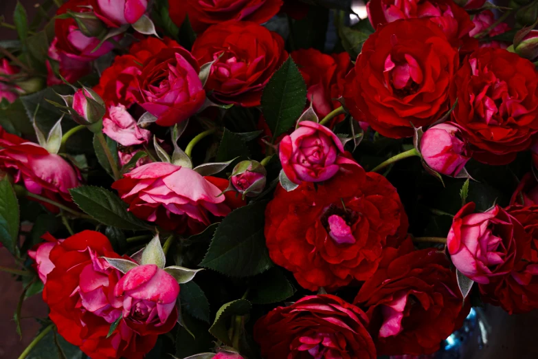 a bouquet of red flowers on display in the middle of the table