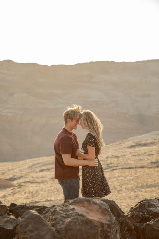 man and woman standing together near rocky area