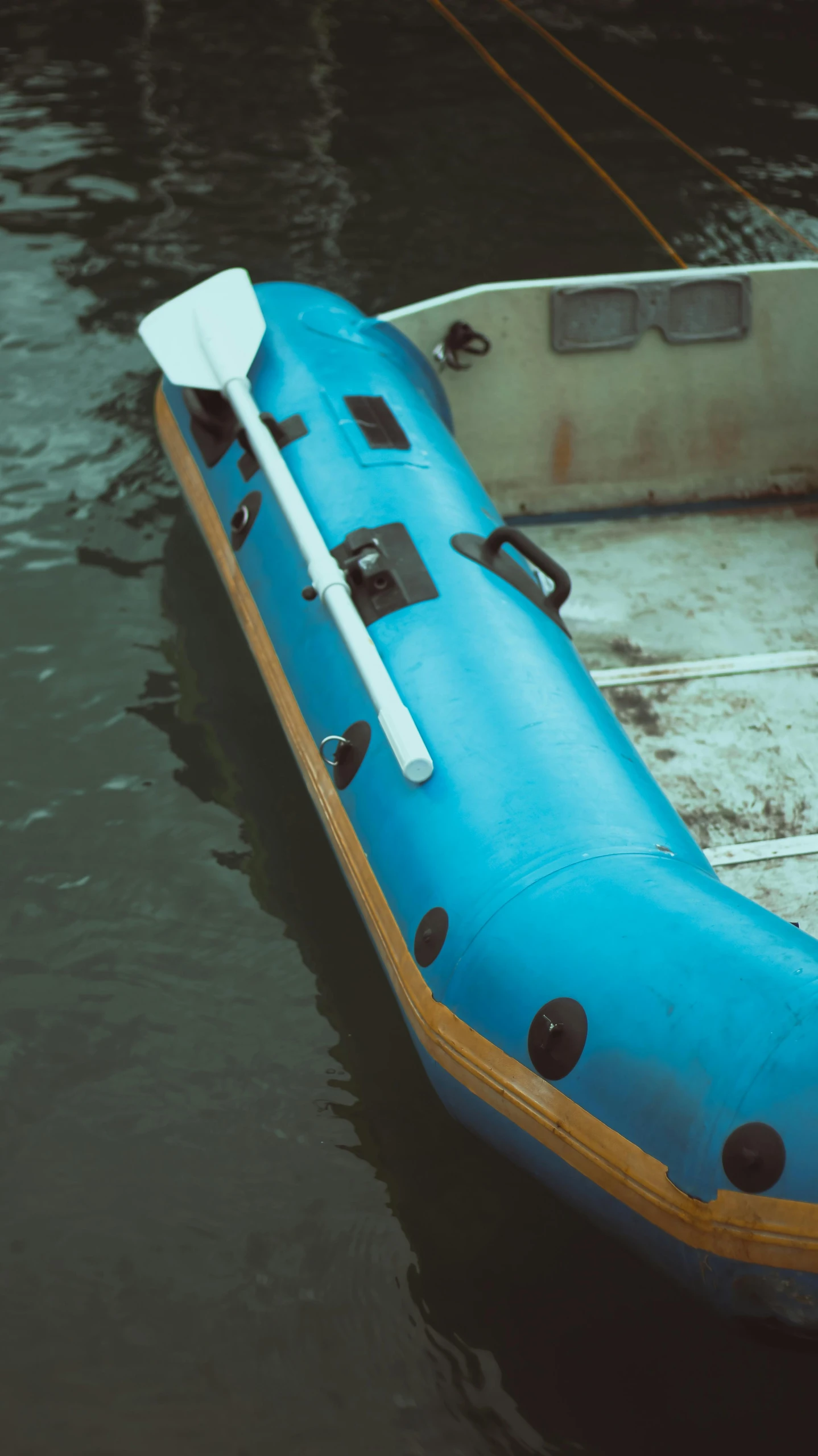 a raft floating on top of a lake with paddle