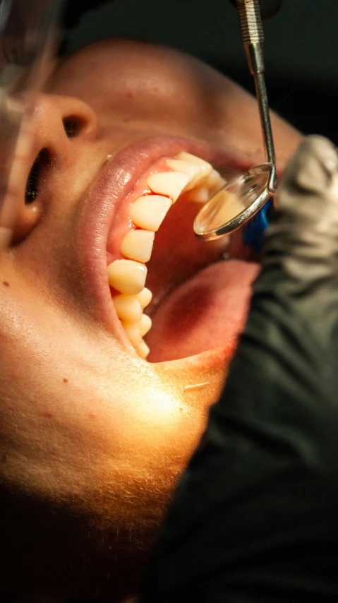the dentist is examining the teeth of a man
