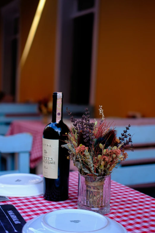 a close - up of a table, with a bottle of wine next to it