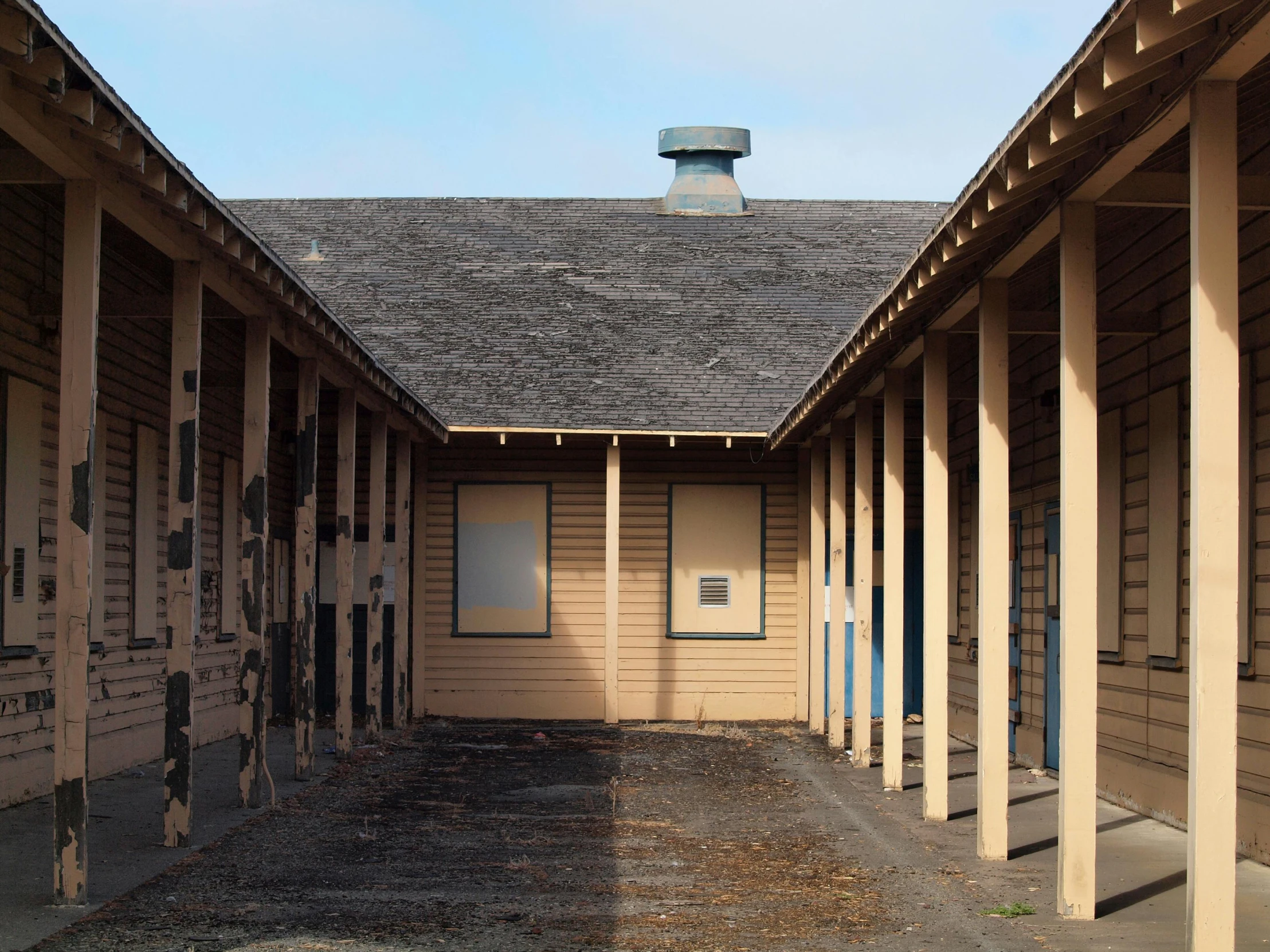 a very long row of wooden buildings with multiple windows