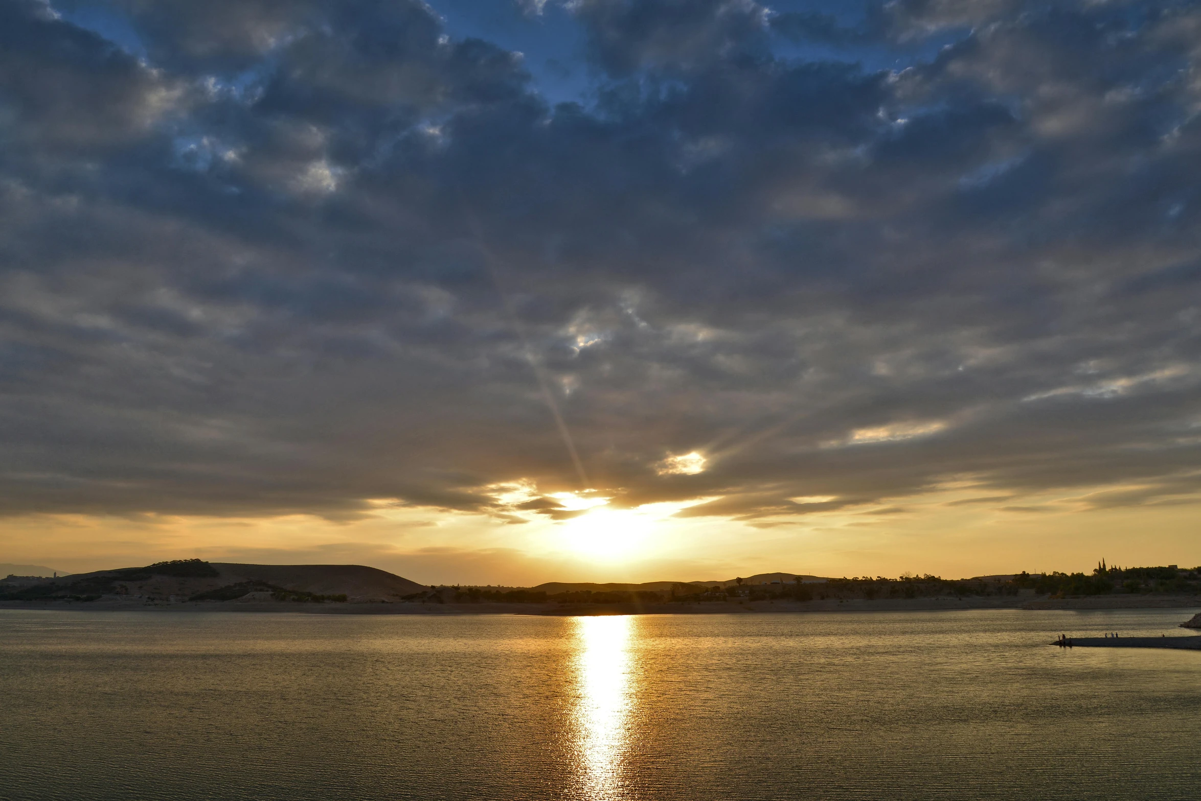 the sun is setting over a body of water