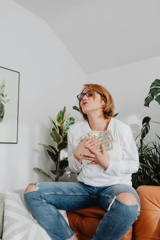 a woman is sitting on a couch with an object