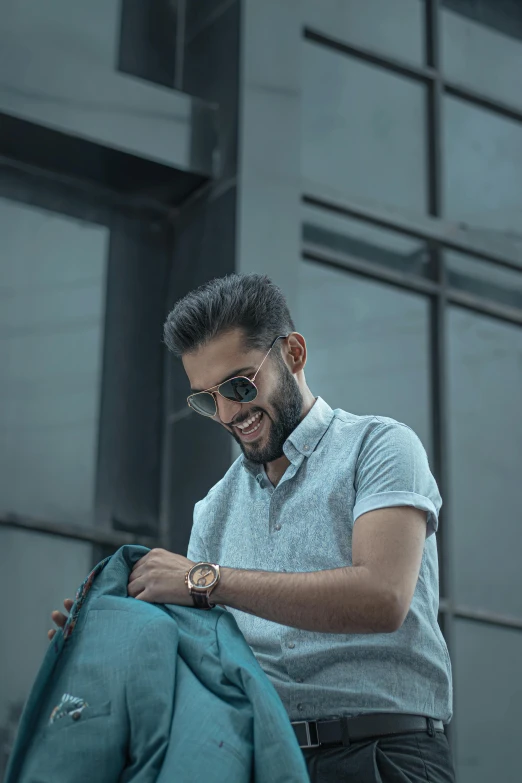 a man with glasses on  fabric to make a blue shirt