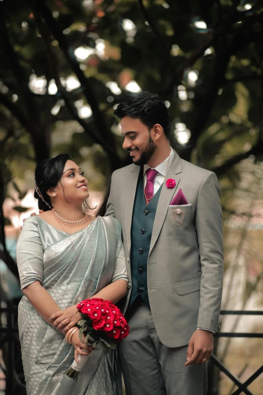 a man and a woman in a suit pose for the camera