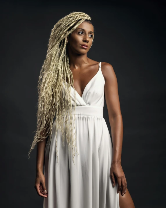 a woman with very long hair and dreadlocks wearing a white dress