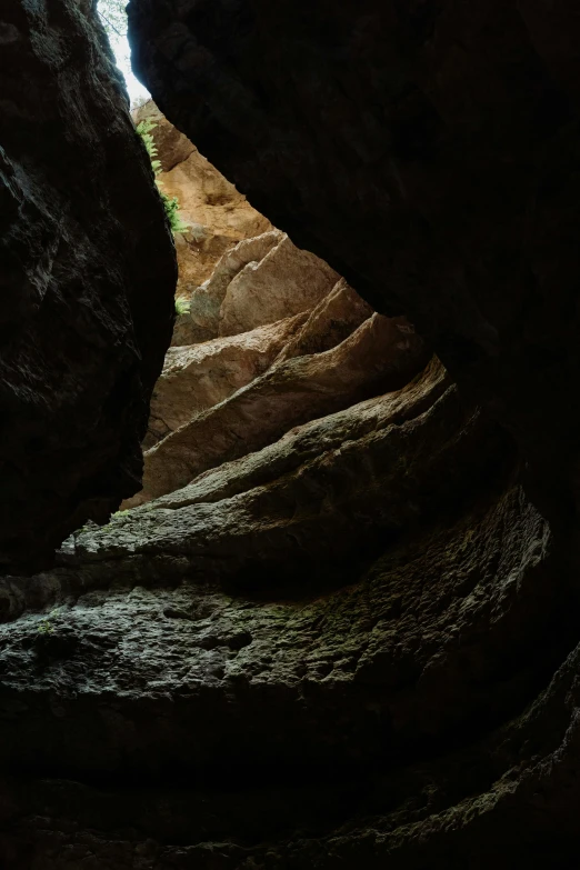 looking up into a slot in the floor of a cave