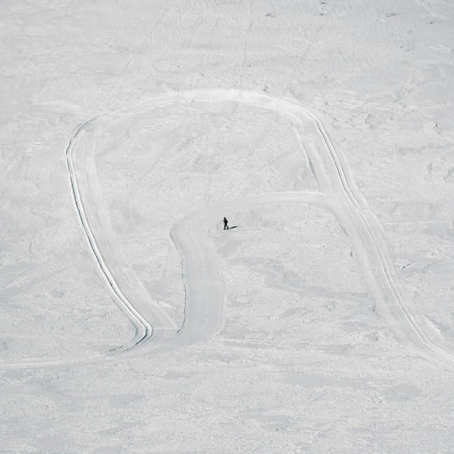 the skier is skiing in the very white snow