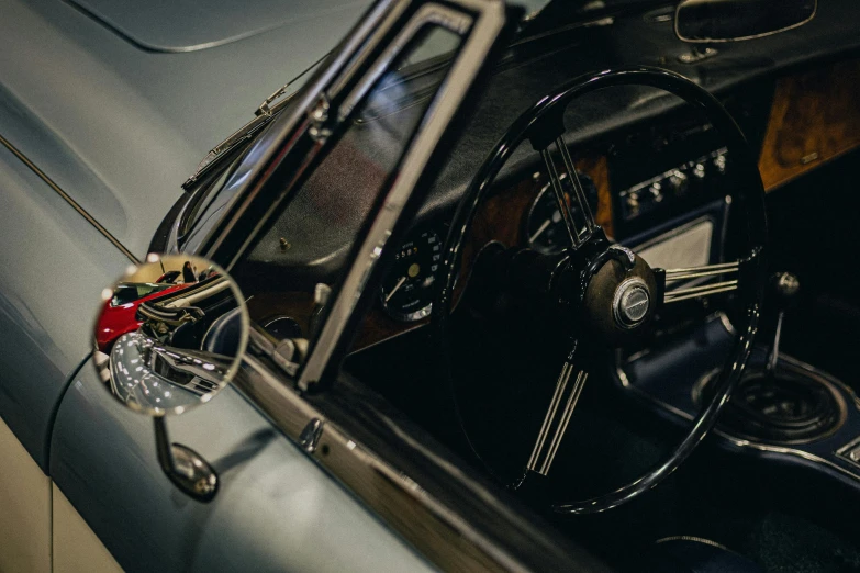 a vintage car is shown with its door open