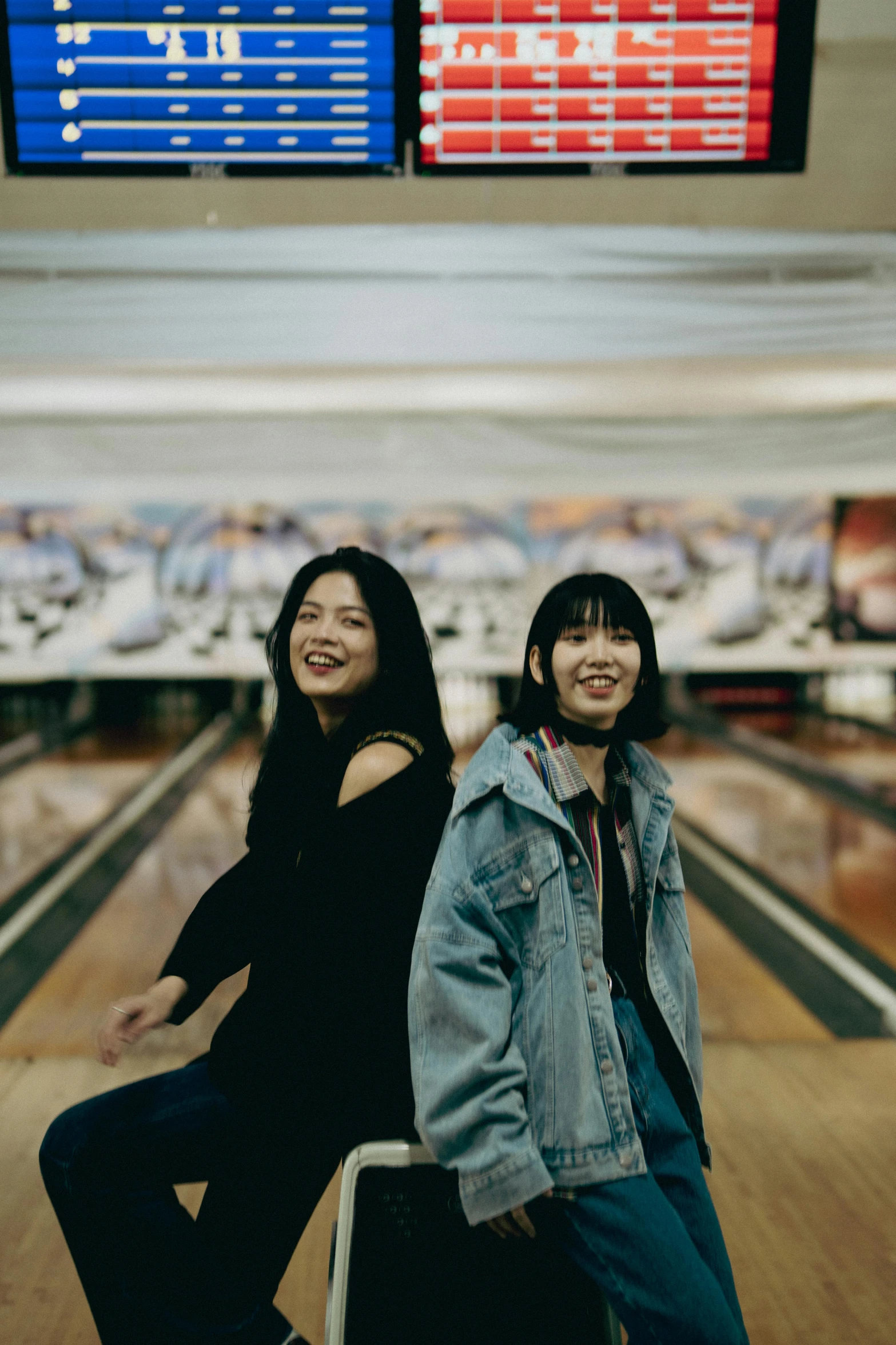 two women pose at an airport for a po