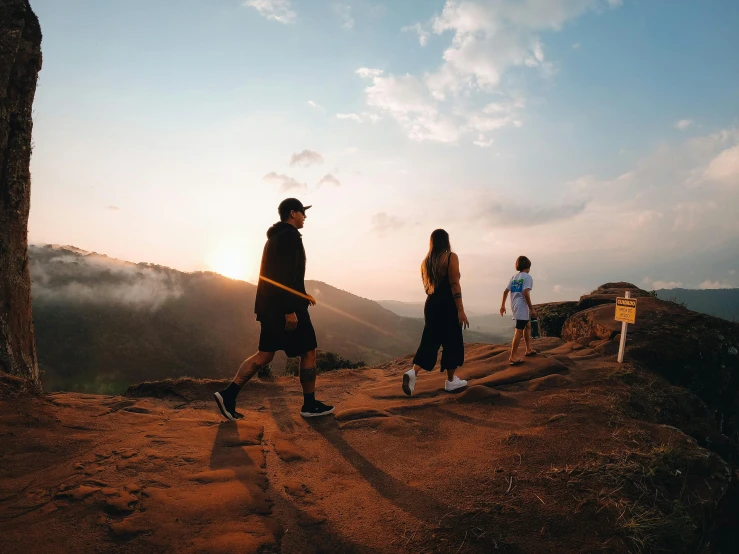 a group of s standing on a rocky hilltop