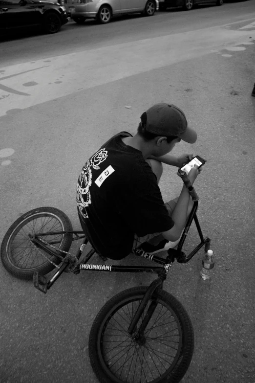 a man sitting on top of a black bike