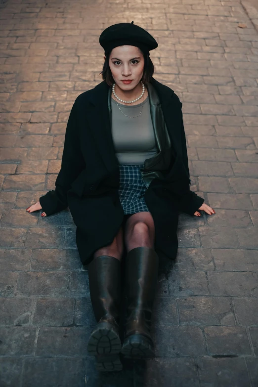 a woman wearing black hat and sitting down