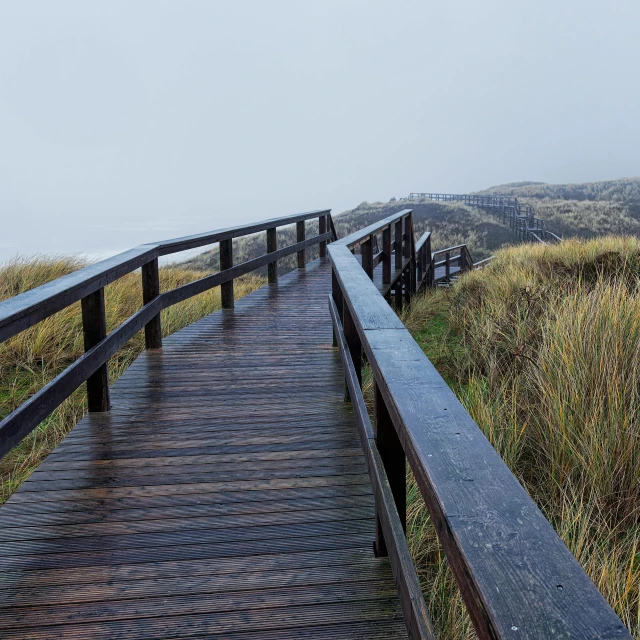 a wooden walkway leading to the top of a mountain