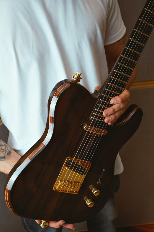 a person holding a guitar in their hands