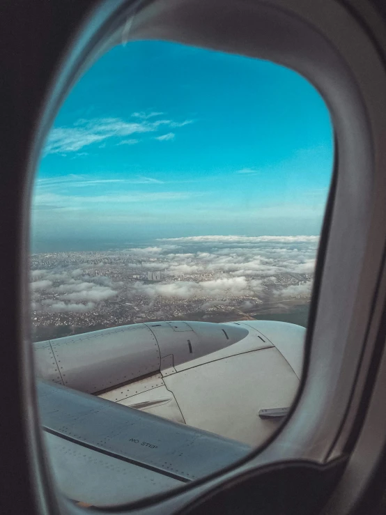 view out an airplane window looking over a city